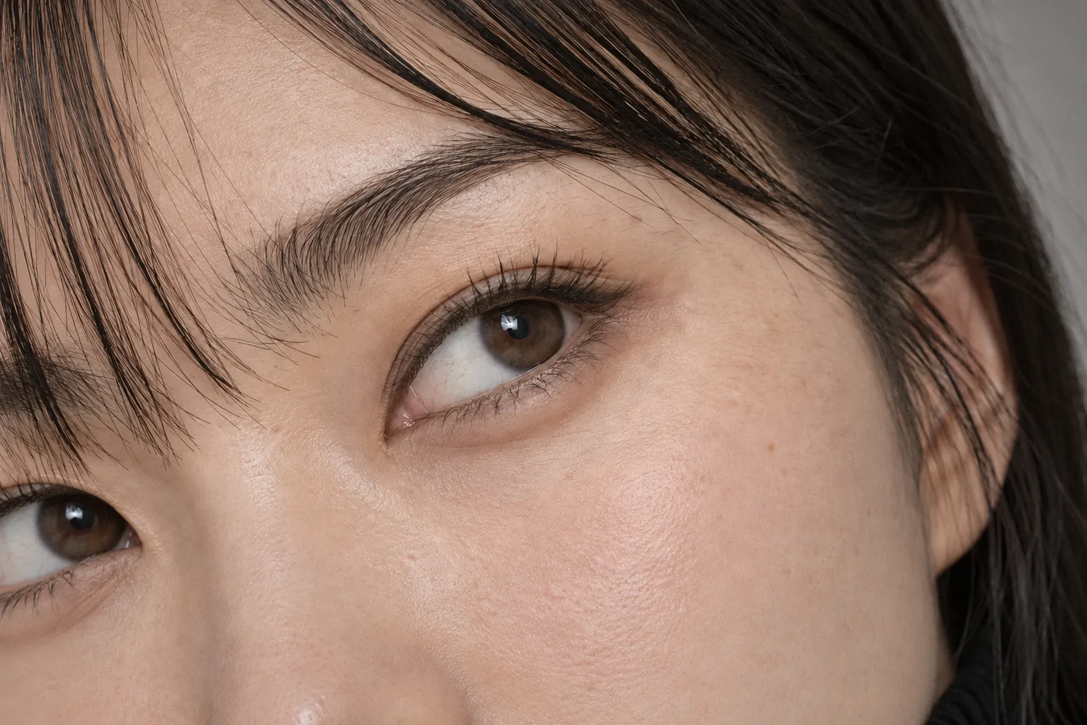 Eye and brow close-up with natural hair flow