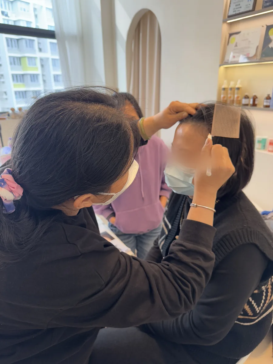 A student measuring brow position with a brow ruler