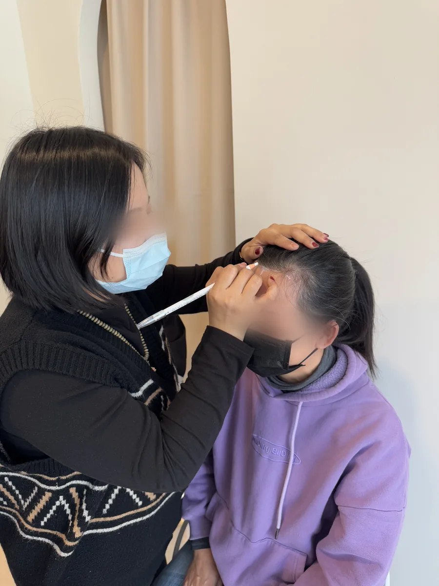 A student designing a model's brows